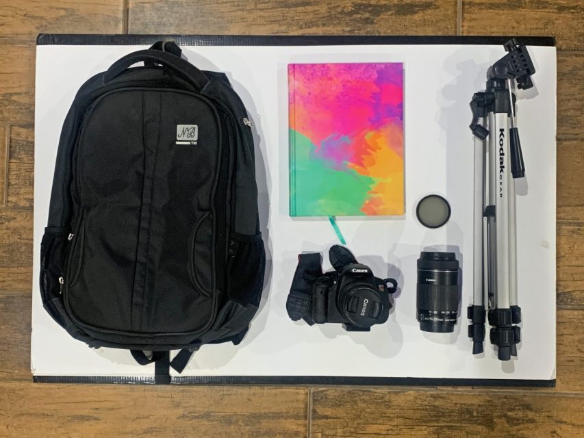 bag and notebook and camera and lens and polarizer and tripod